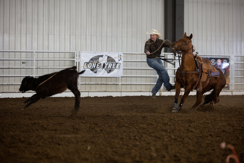 A competitor in the roping event jumps from his horse as he goes in to rope the calf during the March 11 Winter Rodeo at the Jefferson County Fairgrounds.